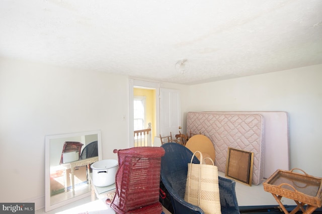 living area featuring a textured ceiling