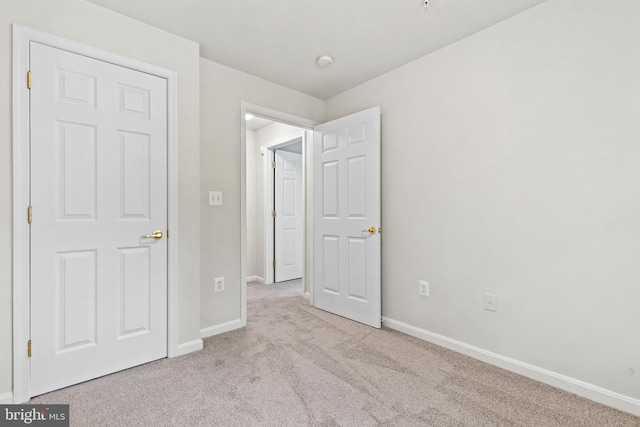 unfurnished bedroom with light colored carpet