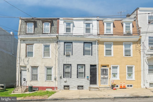 multi unit property with entry steps, cooling unit, and mansard roof