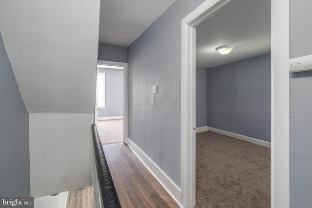 hallway with hardwood / wood-style flooring