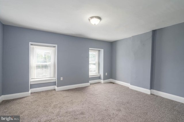 carpeted spare room with plenty of natural light