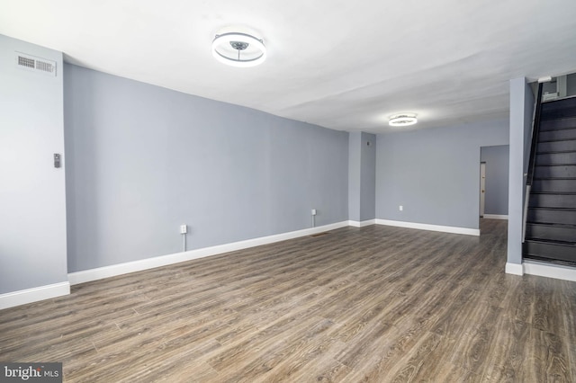 basement with dark hardwood / wood-style floors