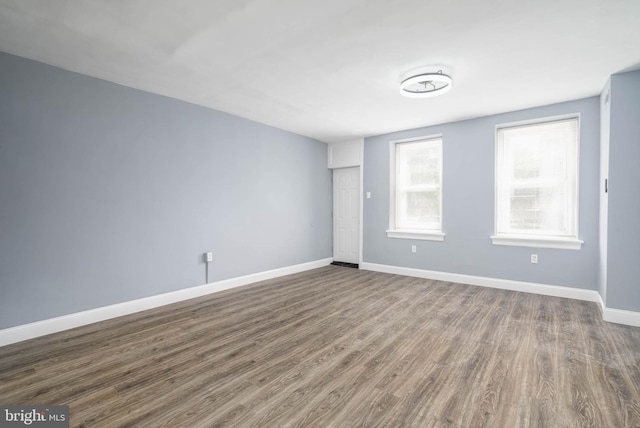 empty room featuring dark hardwood / wood-style flooring