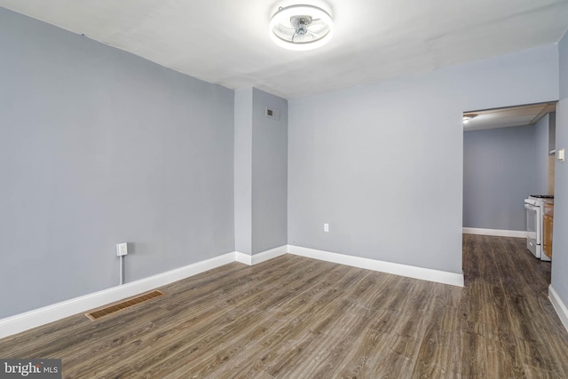 spare room featuring dark wood-type flooring