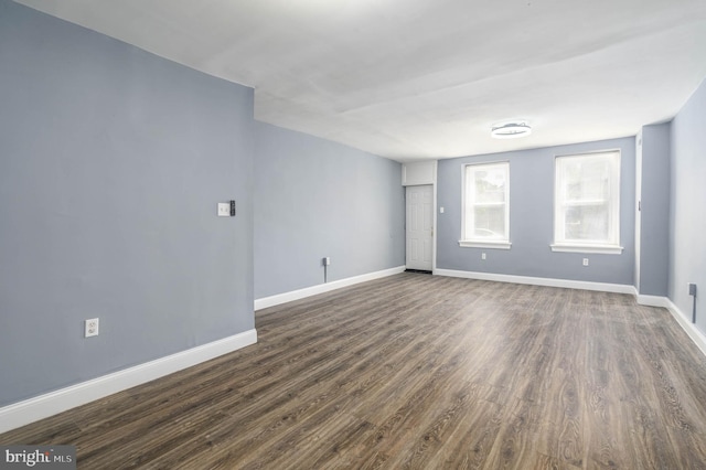 unfurnished room featuring dark wood-type flooring