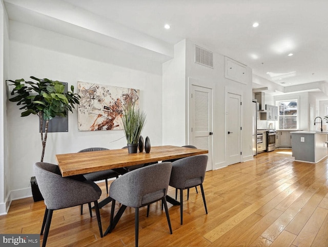 dining area featuring light hardwood / wood-style floors and sink