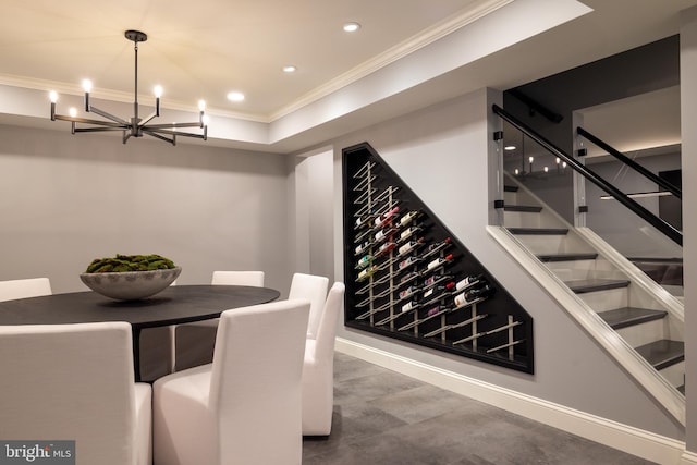 wine cellar with an inviting chandelier and ornamental molding