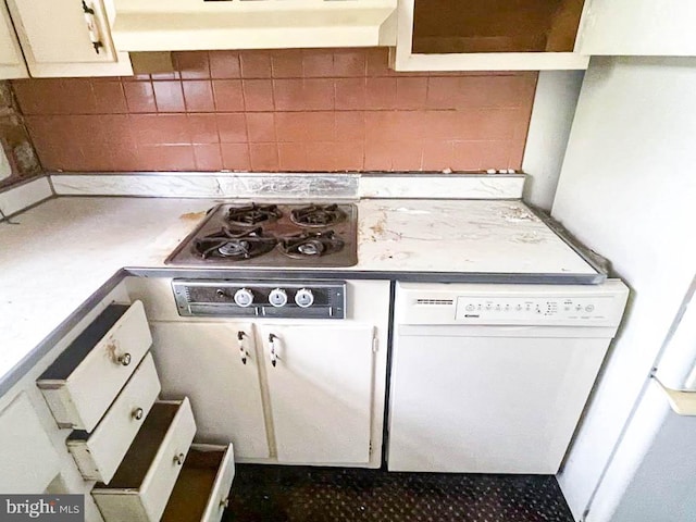 kitchen with gas stovetop, white dishwasher, backsplash, white cabinets, and exhaust hood