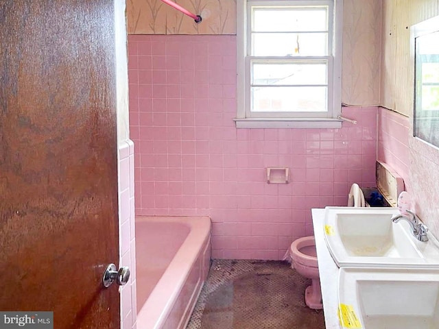 bathroom with tile walls, vanity, and toilet