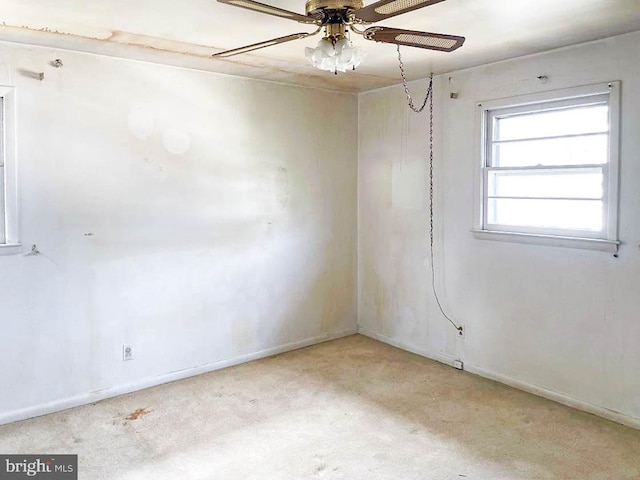 empty room with ceiling fan and light colored carpet