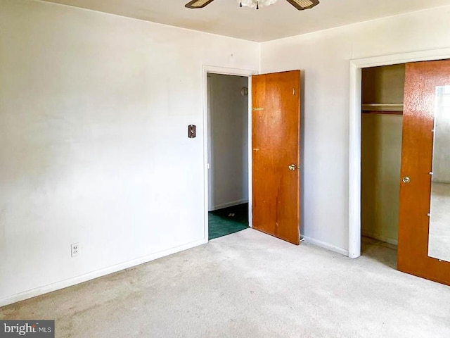 unfurnished bedroom featuring ceiling fan, a closet, and carpet