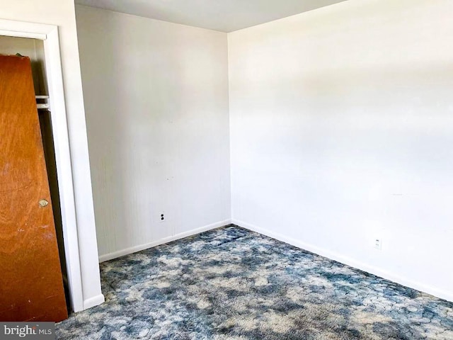 empty room with dark carpet