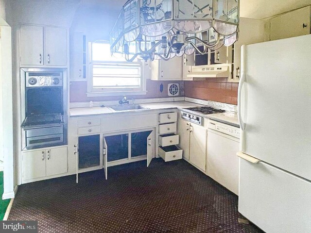 kitchen featuring sink, white appliances, and white cabinetry