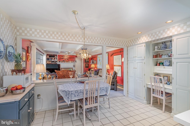 kitchen featuring pendant lighting, light tile patterned floors, crown molding, built in shelves, and kitchen peninsula