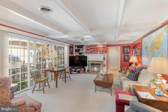 carpeted living room with beamed ceiling, plenty of natural light, and ceiling fan