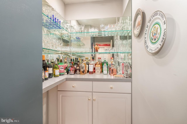 bar with white cabinetry