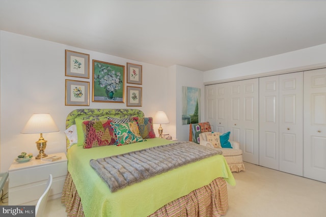 bedroom featuring light colored carpet and a closet