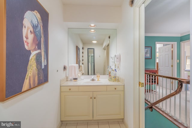 bathroom featuring tile patterned flooring, vanity, and ornamental molding