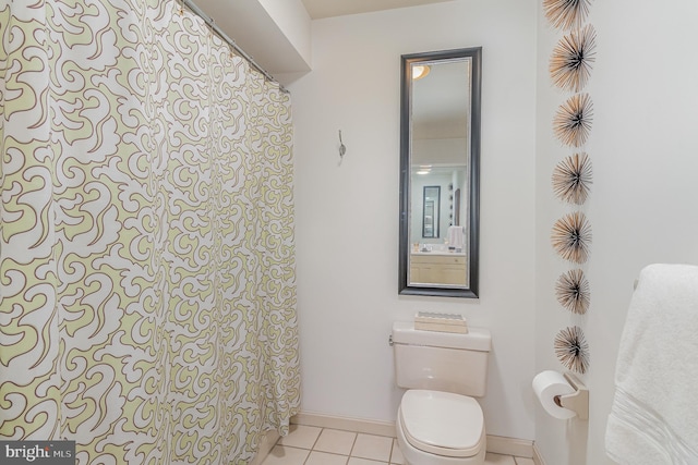 bathroom featuring toilet and tile patterned flooring