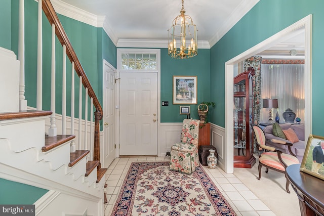 tiled entrance foyer with a notable chandelier and crown molding