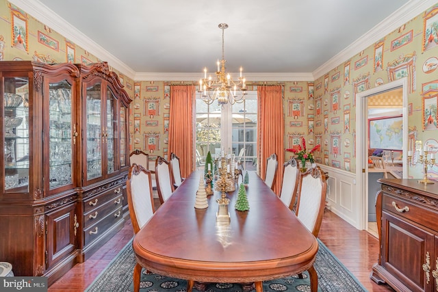 dining room featuring wood-type flooring, a notable chandelier, and crown molding