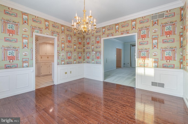 17 Kensington Sq, Mechanicsburg, PA 17050 - unfurnished room featuring a wainscoted wall, a chandelier, wood finished floors, a decorative wall, and ornamental molding
