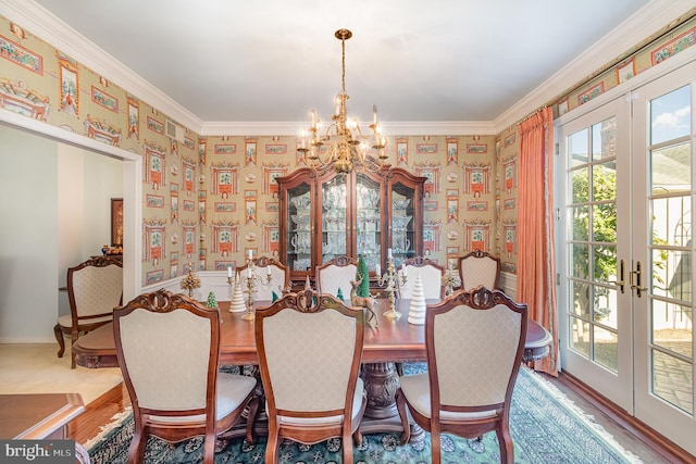 dining room with hardwood / wood-style flooring, ornamental molding, and french doors