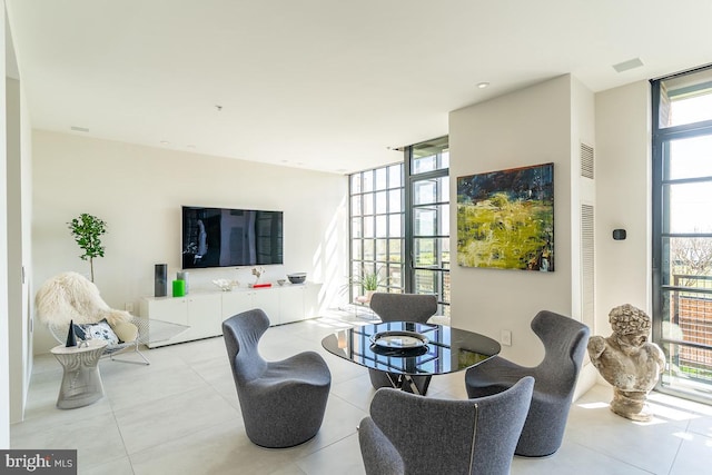 living room with plenty of natural light and floor to ceiling windows