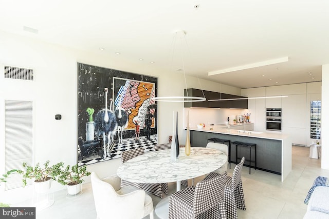 dining space featuring light tile patterned floors