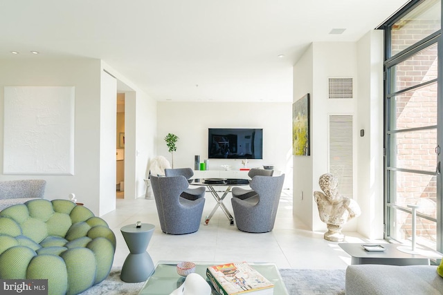 tiled living room with a wall of windows and a wealth of natural light