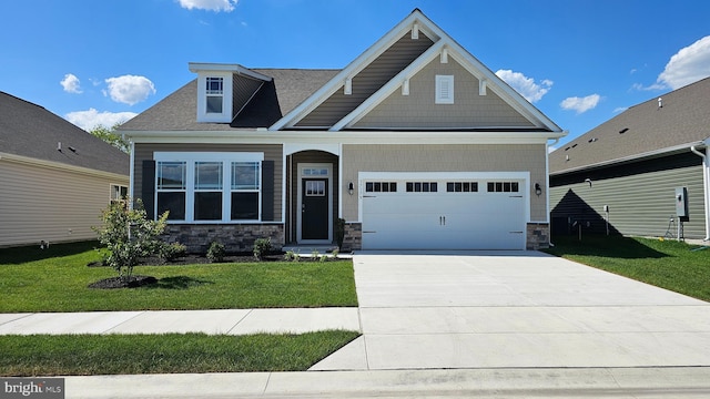 craftsman-style house featuring a garage and a front lawn