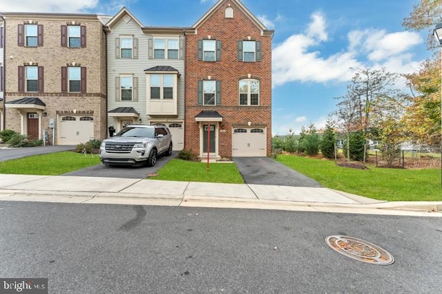 townhome / multi-family property featuring a garage and a front yard