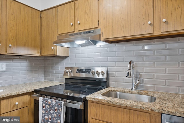 kitchen with stainless steel electric stove, sink, wine cooler, decorative backsplash, and light stone countertops