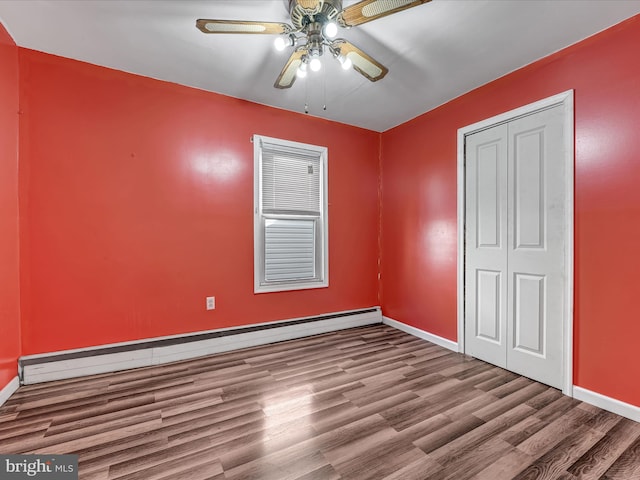 unfurnished bedroom with a closet, light hardwood / wood-style floors, a baseboard radiator, and ceiling fan