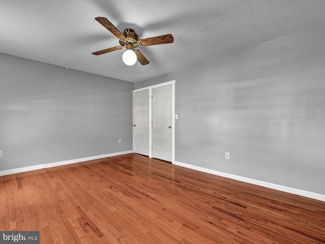 empty room featuring hardwood / wood-style floors and ceiling fan