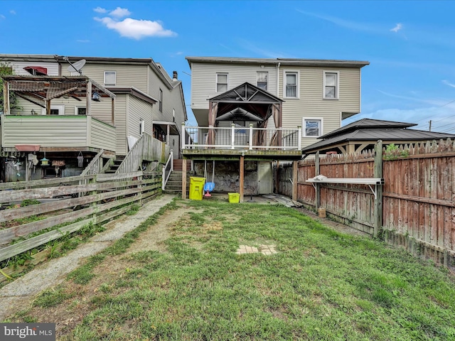 back of house with a gazebo, a yard, and a wooden deck