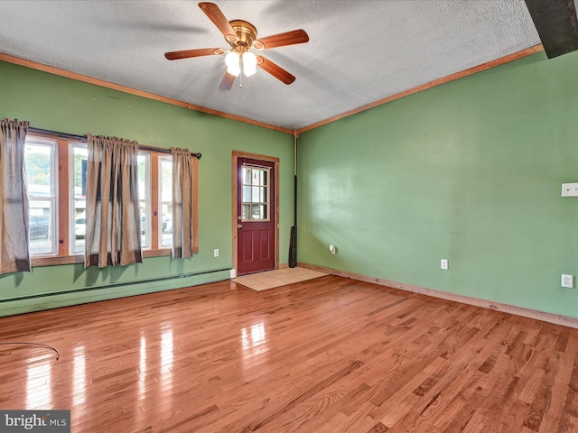 entrance foyer with ceiling fan, a baseboard radiator, light hardwood / wood-style flooring, and a textured ceiling