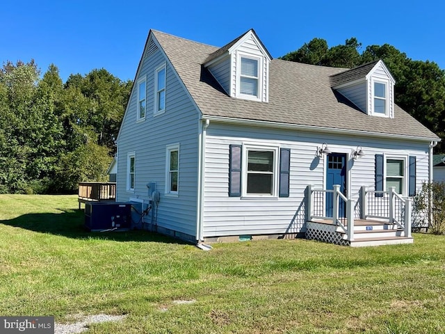 cape cod house featuring central air condition unit, a wooden deck, and a front lawn