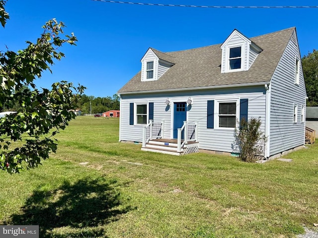 cape cod-style house with a front yard