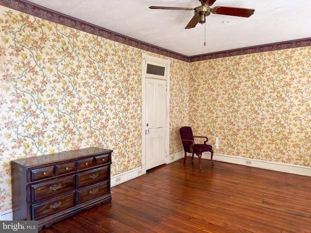 unfurnished room with ornamental molding, dark hardwood / wood-style floors, and ceiling fan