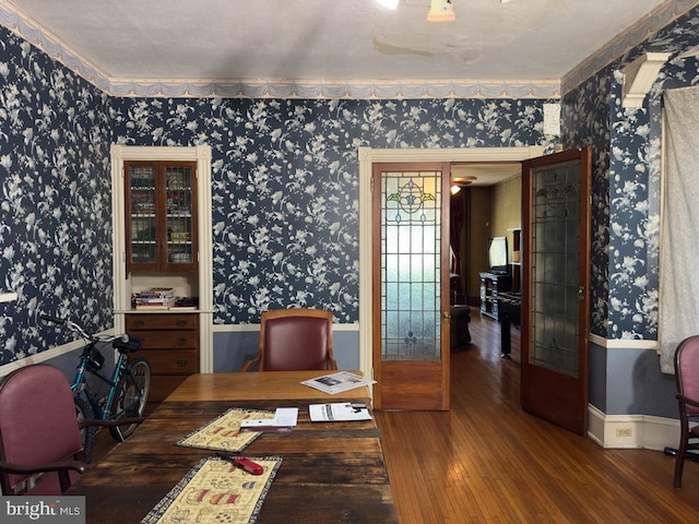 dining space with crown molding and hardwood / wood-style flooring