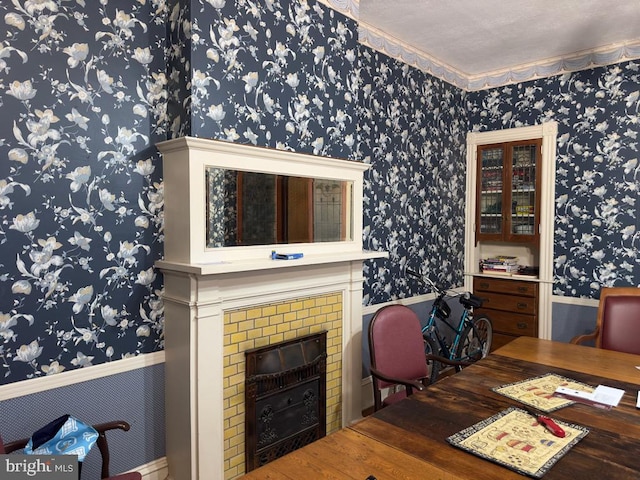 dining area with ornamental molding, hardwood / wood-style floors, and a textured ceiling