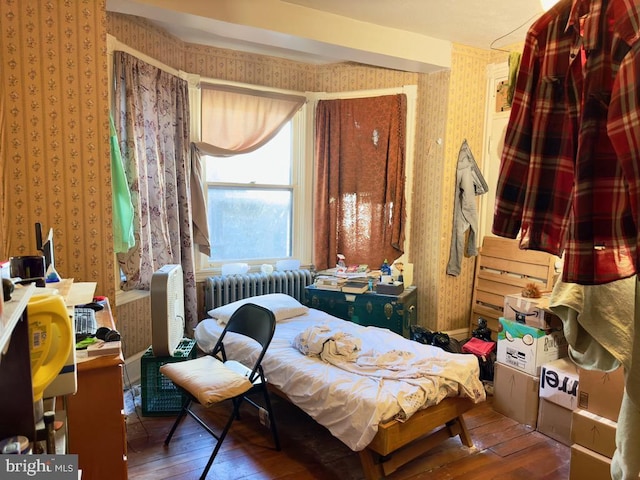 bedroom with wood-type flooring and radiator