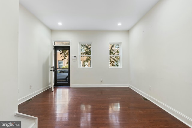 unfurnished room with dark hardwood / wood-style floors