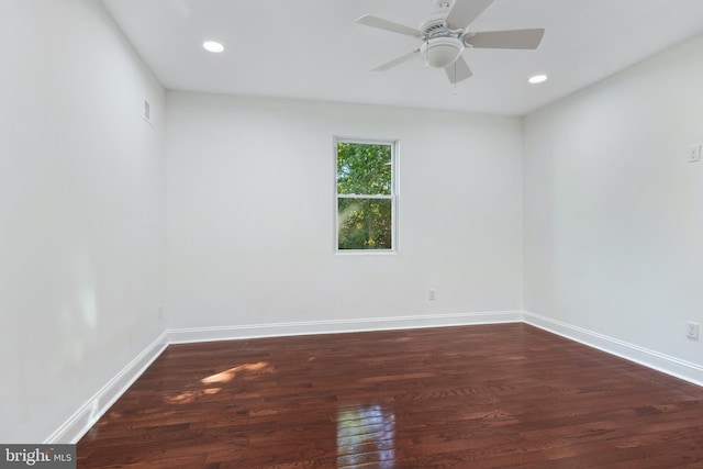 empty room featuring dark hardwood / wood-style flooring and ceiling fan