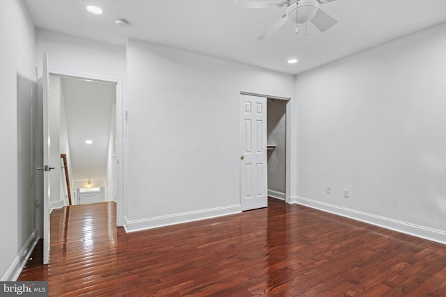 unfurnished bedroom featuring ceiling fan and dark wood-type flooring