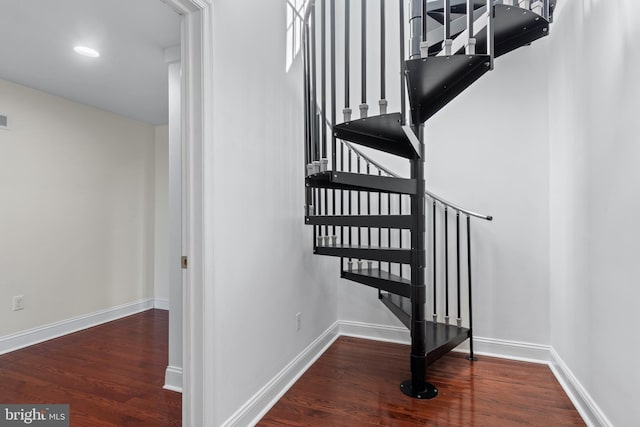 stairway with hardwood / wood-style floors