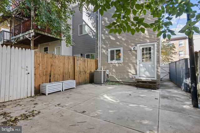 exterior space with central AC unit and a patio area