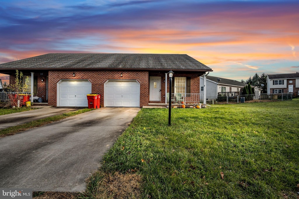 view of front facade featuring a garage and a lawn