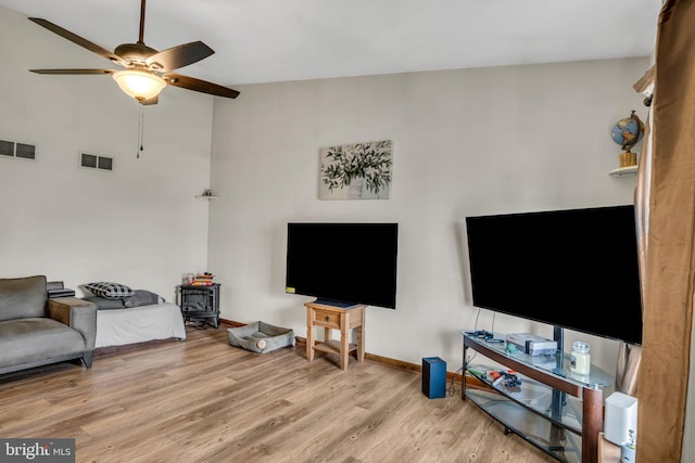 living room with vaulted ceiling, light hardwood / wood-style flooring, and ceiling fan